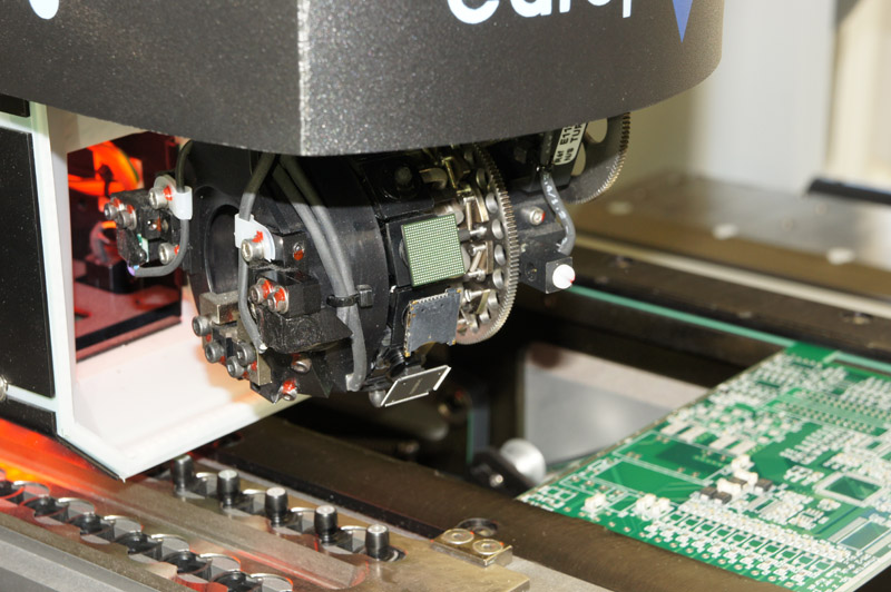 Real SMT pick-and-place head operating above a printed circuit board